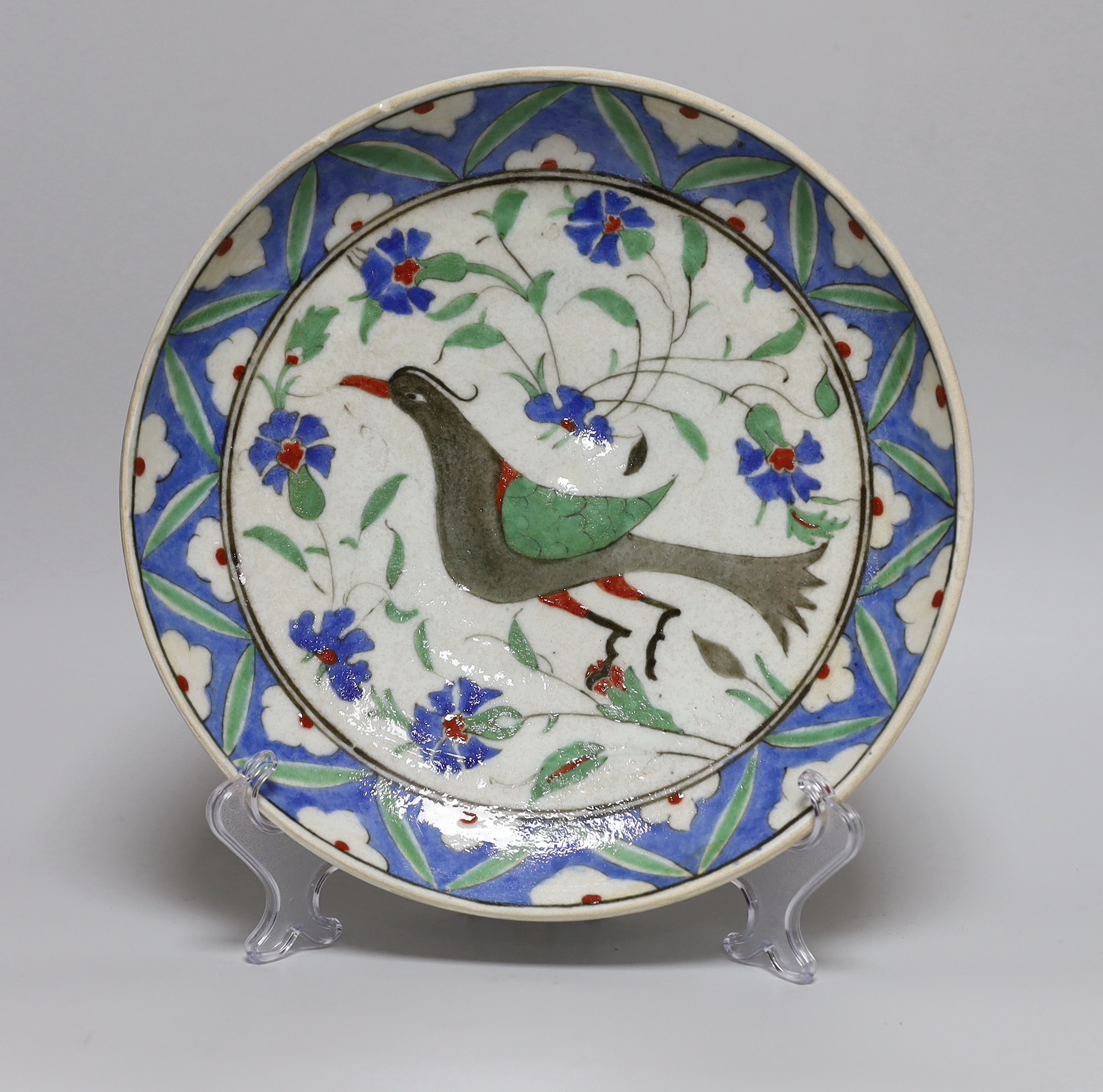 A Turkish Isnik style plate decorated with a bird amongst flowers, 29.5cm in diameter